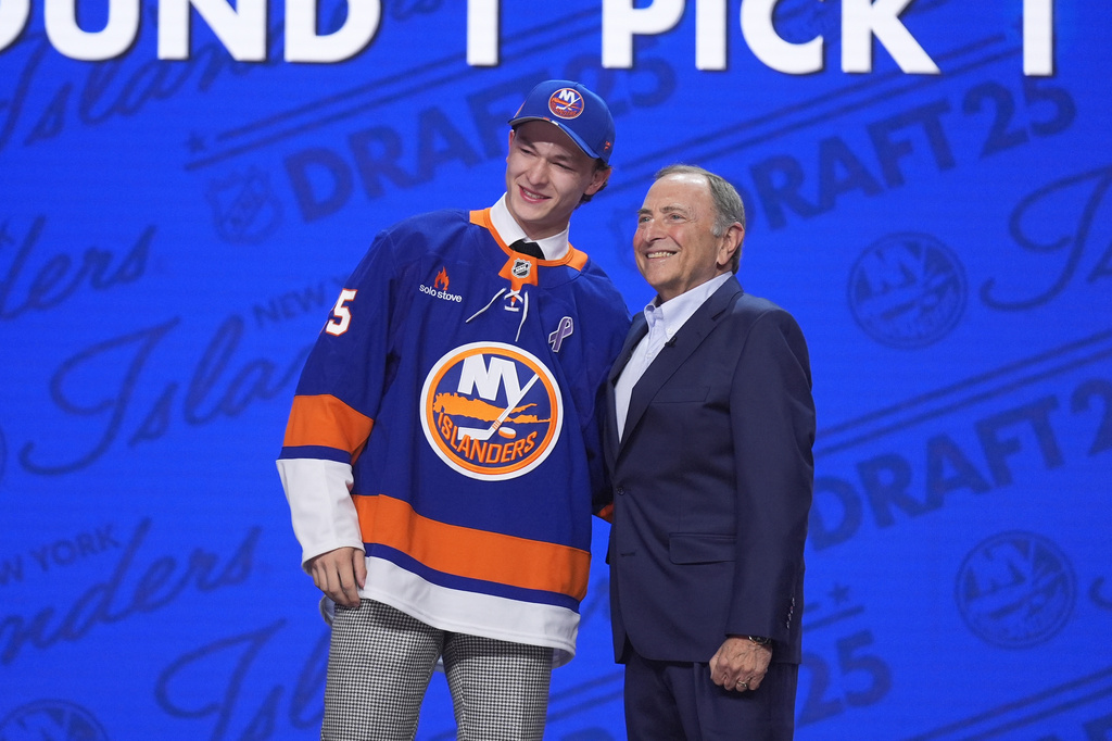 FILE - Matthew Schaefer, left, stands with NHL commissioner Gary Bettman after being drafted by the New York Islanders during the NHL hockey draft Friday, June 27, 2025, in Los Angeles. (AP Photo/Damian Dovarganes, File)