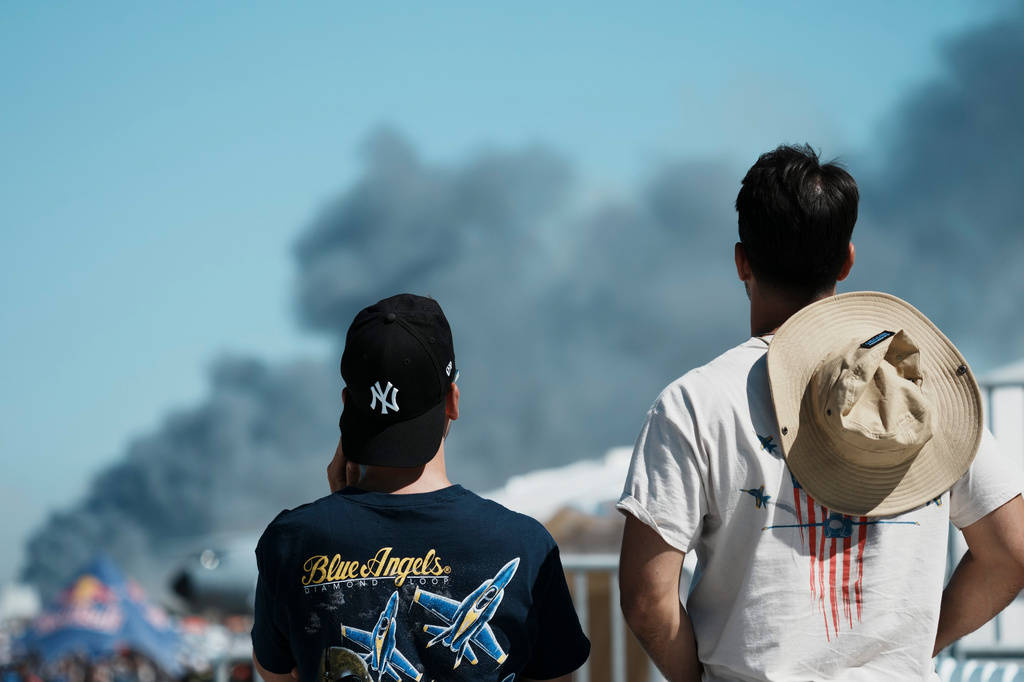 Spectators watch as smoke rises after a Hellenic Air Force F-4 Phantom fighter jet crashed, during the Athens Flying Week airshow at Tanagra Air Force Base, north of Athens, Greece, Saturday, Sept. 5, 2026. (AP Photo/Kallista Allaway)