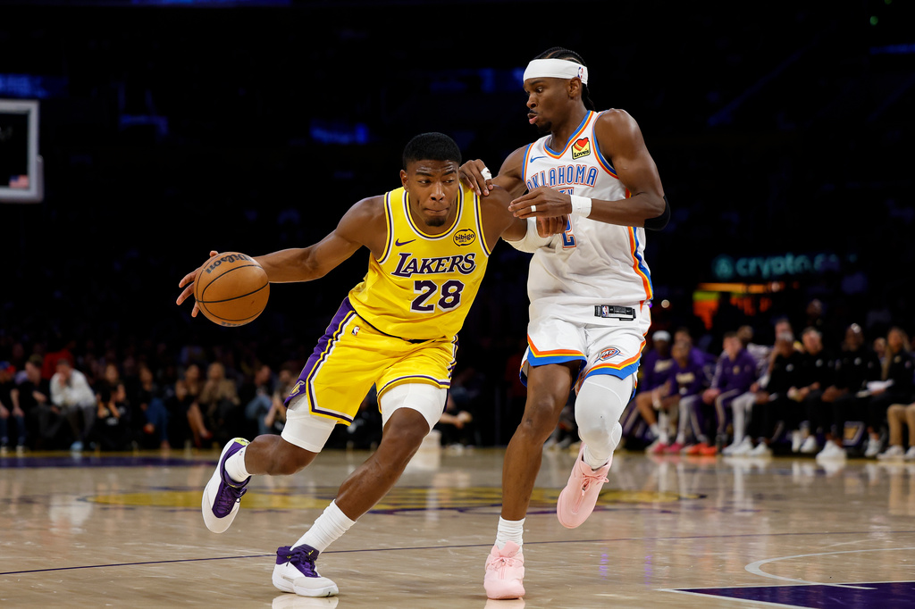 Los Angeles Lakers forward Rui Hachimura (28) runs with the ball while being guarded by Oklahoma City Thunder guard Shai Gilgeous-Alexander (2) during the first half of an NBA basketball game Tuesday, April 7, 2026, in Los Angeles. (AP Photo/Caroline Brehman)