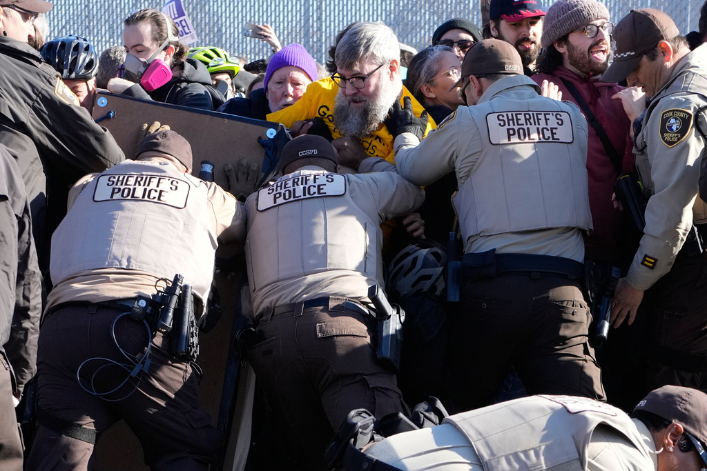 Cook County Sheriff Police guard protesters outside an ICE processing facility in the Chicago suburb of Broadview, Ill., Friday, Nov. 14, 2025. (AP Photo/Nam Y. Huh)