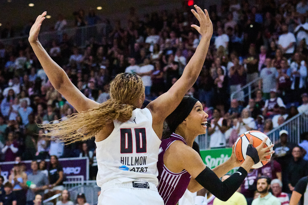 Toronto Tempo's Isabelle Harrison, right, drives to the net past Atlanta Dream's Naz Hillmon (00) during the first half of a WNBA basketball game in Toronto, Friday, July 17, 2026. (Sammy Kogan/The Canadian Press via AP)