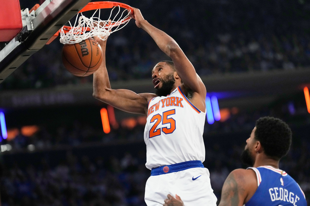 New York Knicks' Mikal Bridges dunks the ball during the first half of Game 1 in a second-round NBA basketball playoffs series against the Philadelphia 76ers Monday, May 4, 2026, in New York. (AP Photo/Seth Wenig)