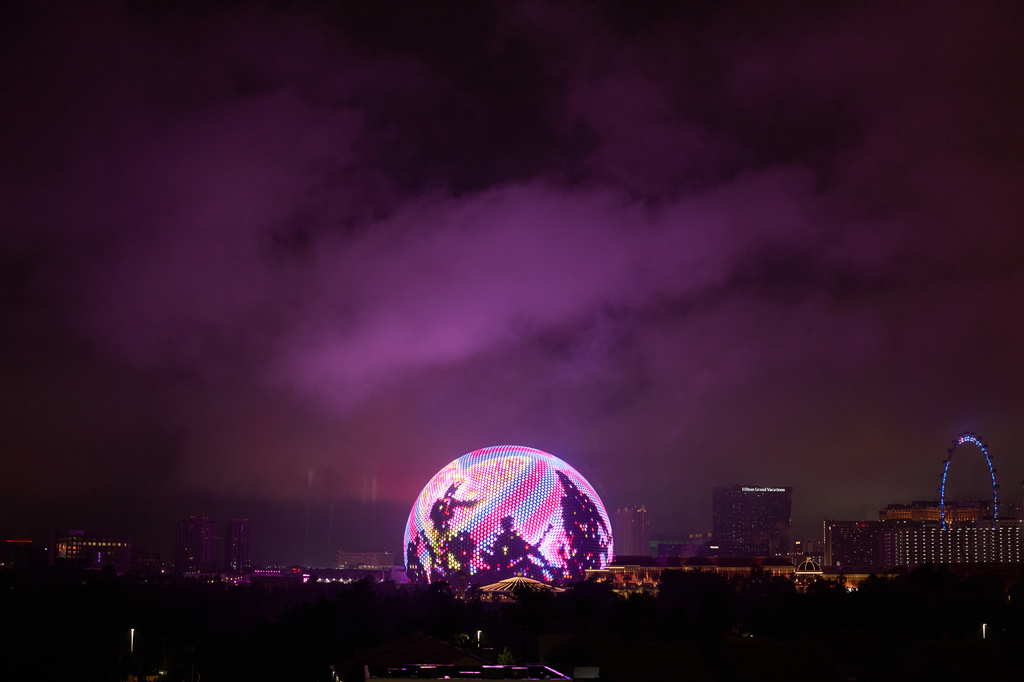 FILE - Lights from the Sphere illuminate rain clouds above The Strip, Nov. 15, 2025, in Las Vegas. (AP Photo/John Locher, File)