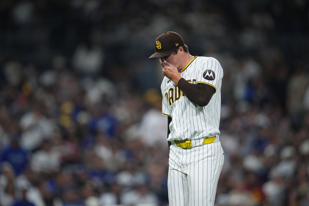 San Diego Padres pitcher Mason Miller reacts after giving up a sacrifice fly during the ninth inning of a baseball game against the Los Angeles Dodgers Tuesday, May 19, 2026, in San Diego. (AP Photo/Gregory Bull)