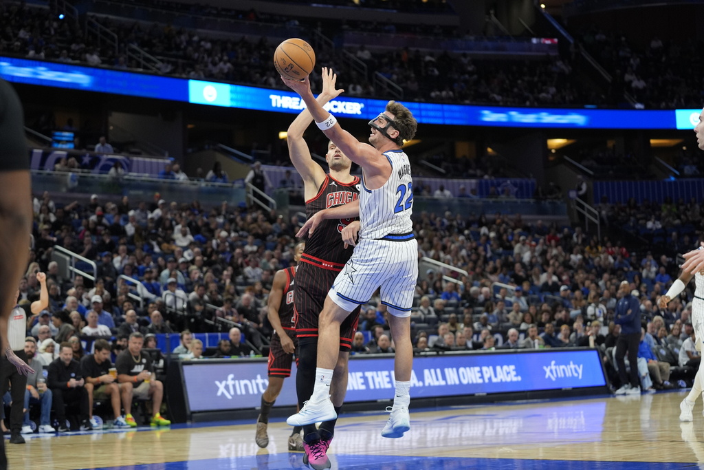 Orlando Magic forward Franz Wagner, makes a shot over Chicago Bulls center Nikola Vucevic during the first half of an NBA basketball game, Monday, Dec. 1, 2025, in Orlando, Fla. (AP Photo/John Raoux)
