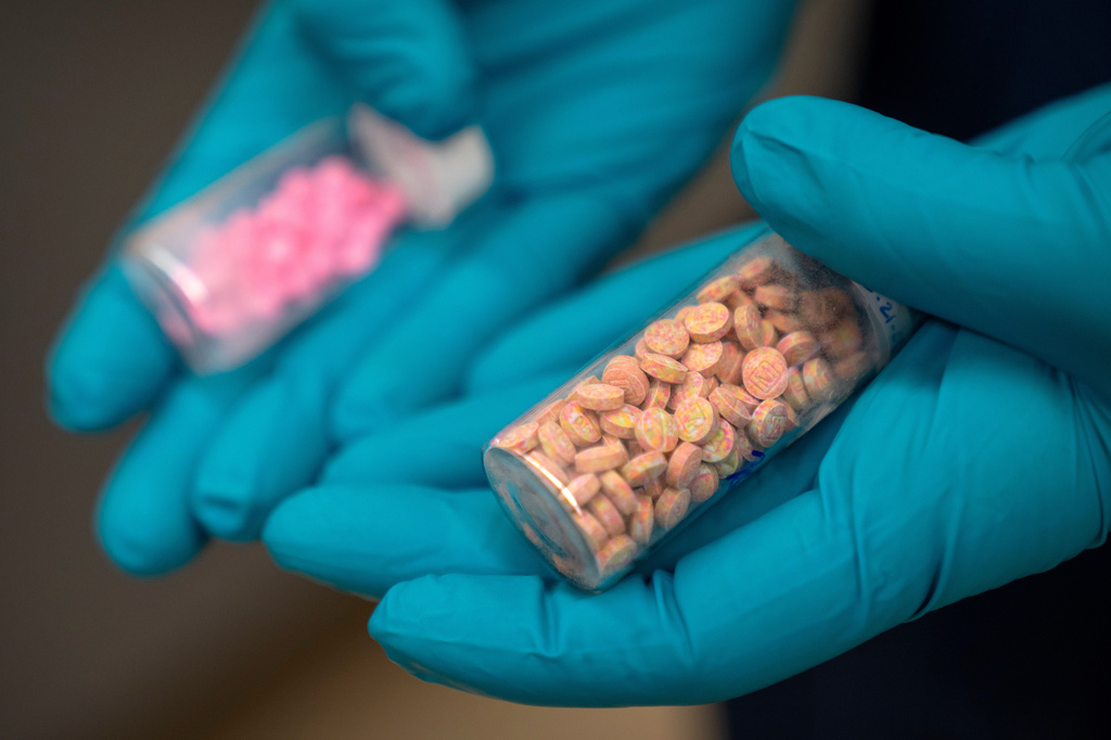 FILE - Jonathan Dumke, a senior forensic chemist with the Drug Enforcement Administration, holds vials of fentanyl pills at a DEA research laboratory on April 29, 2025, in Northern Virginia. (AP Photo/Mark Schiefelbein, File)
