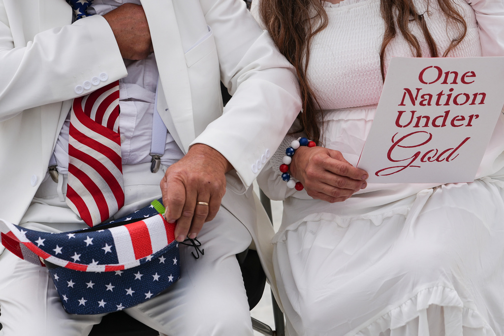 Dorothea and Billy Ohlandt, from North Carolina, arrive at Rededicate 250, a mostly conservative Christian prayer gathering in honor of the United States' 250th anniversary, on the National Mall, Sunday, May 17, 2026, in Washington. (AP Photo/Julia Demaree Nikhinson)