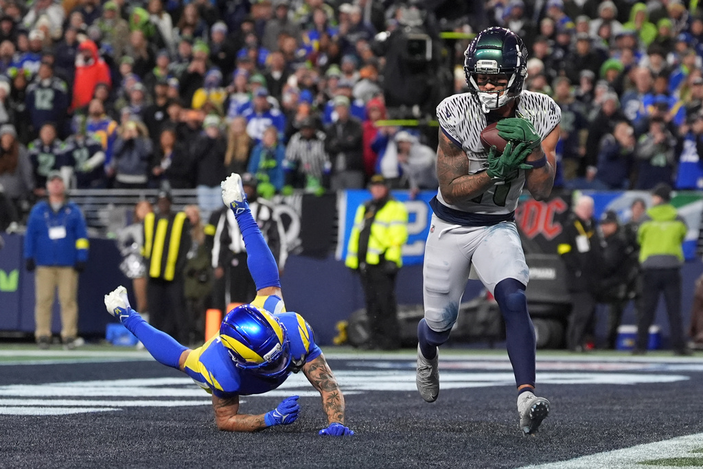 Seattle Seahawks wide receiver Jaxon Smith-Njigba (11) scores a touchdown during overtime in an NFL football game against the Los Angeles Rams, Thursday, Dec. 18, 2025, in Seattle. (AP Photo/Lindsey Wasson)