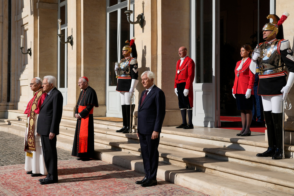 Italian President Sergio Mattarella, second from right, welcomes Pope Leo XIV as he arrives at the Quirinale Presidential Palace in Rome, Tuesday, Oct. 14, 2025. (AP Photo/Gregorio Borgia)