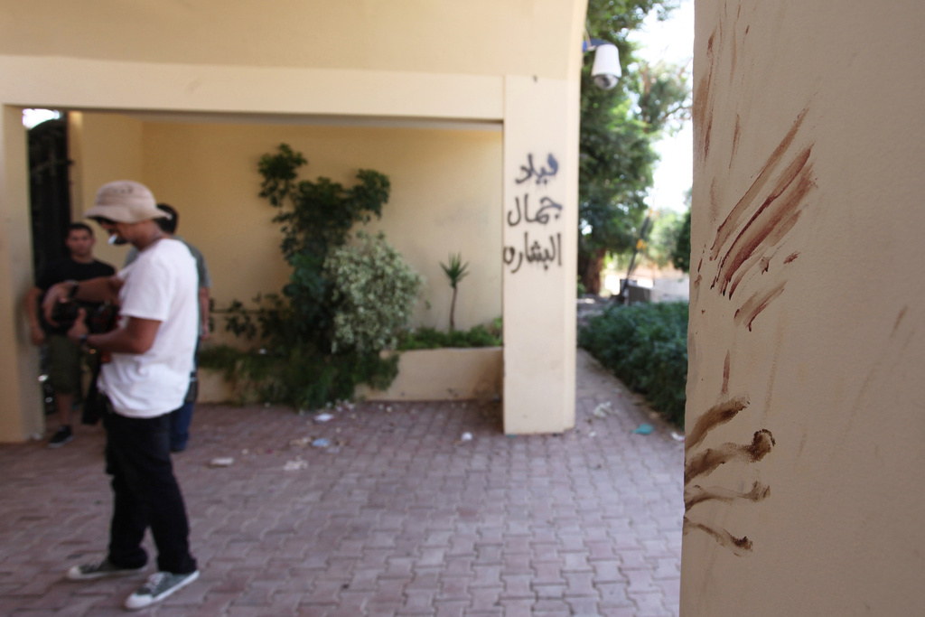 FILE - Bloodstains, believed to be from one of the American staff members of the U.S. Consulate, are seen Sept. 13, 2012, at the main gate after an attack that killed four Americans, including Ambassador Chris Stevens, on the night of Sept. 11, 2012, in Benghazi, Libya. (AP Photo/Mohammad Hannon, File)