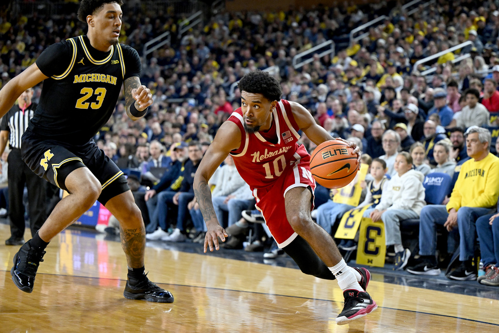 Nebraska guard Jamarques Lawrence (10) drives the baseline against Michigan forward Yaxel Lendeborg (23) in the first half of an NCAA college basketball game in Ann Arbor, Mich., Tuesday, Jan. 27, 2026. (AP Photo/Lon Horwedel)