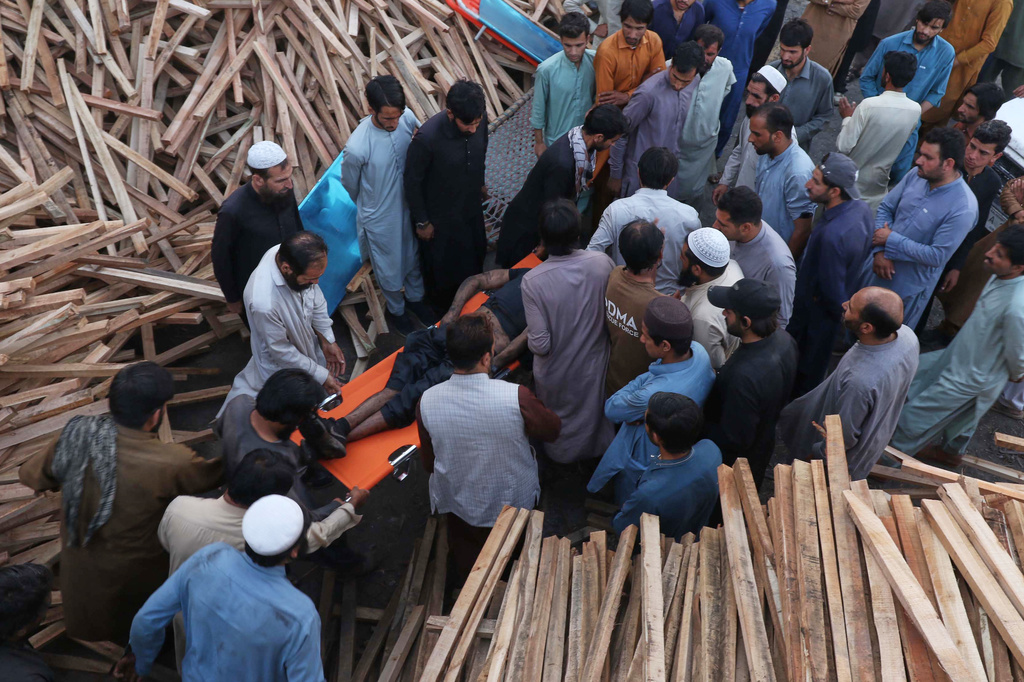 People transport the body of a miner recovered after an explosion inside a coal mine on the outskirts of Quetta, in southwest Pakistan, Thursday, July 30, 2026. (AP Photo/Fazal Tawab)