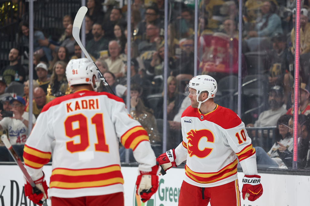 Calgary Flames left wing Jonathan Huberdeau (10) reacts after scoring against the Vegas Golden Knights during the first period of an NHL hockey game Saturday, Oct. 18, 2025, in Las Vegas. (AP Photo/Ian Maule)