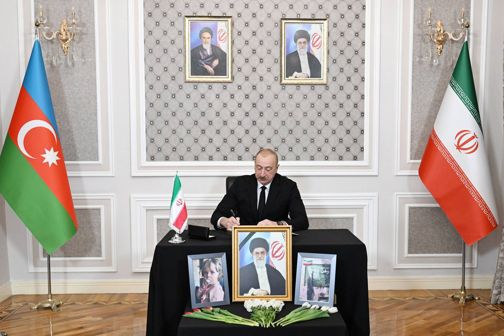 In this photo provided by Azerbaijan's Presidential Press Service, Azebaijan's President Ilham Aliyev writes a message in a condolence book for the late Iranian Supreme Leader Ayatollah Ali Khamenei at the Iranian Embassy in Baku, Azerbaijan, Wednesday, March 4, 2026. (Azerbaijan's Presidential Press Service via AP)