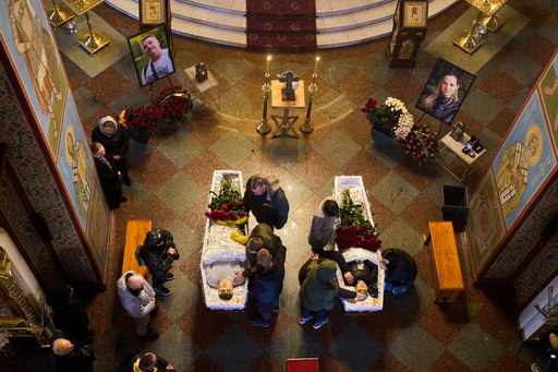 Relatives, colleagues and friends of two Ukrainian 43-year-old journalists Olena Hubanova, who worked under the pseudonym Alyona Gramova, and cameraman Yevhen Karmazin, who were killed on Thursday, Oct. 23, mourn over their coffins during a funeral service at St. Michael Monastery in Kyiv, Ukraine, Monday, Oct. 27, 2025. (AP Photo/Efrem Lukatsky) Relatives, colleagues and friends of two Ukrainian 43-year-old journalists Olena Hubanova, who worked under the pseudonym Alyona Gramova, and cameraman Yevhen Karmazin, who were killed on Thursday, Oct. 23, mourn over their coffins during a funeral service at St. Michael Monastery in Kyiv, Ukraine, Monday, Oct. 27, 2025. (AP Photo/Efrem Lukatsky)