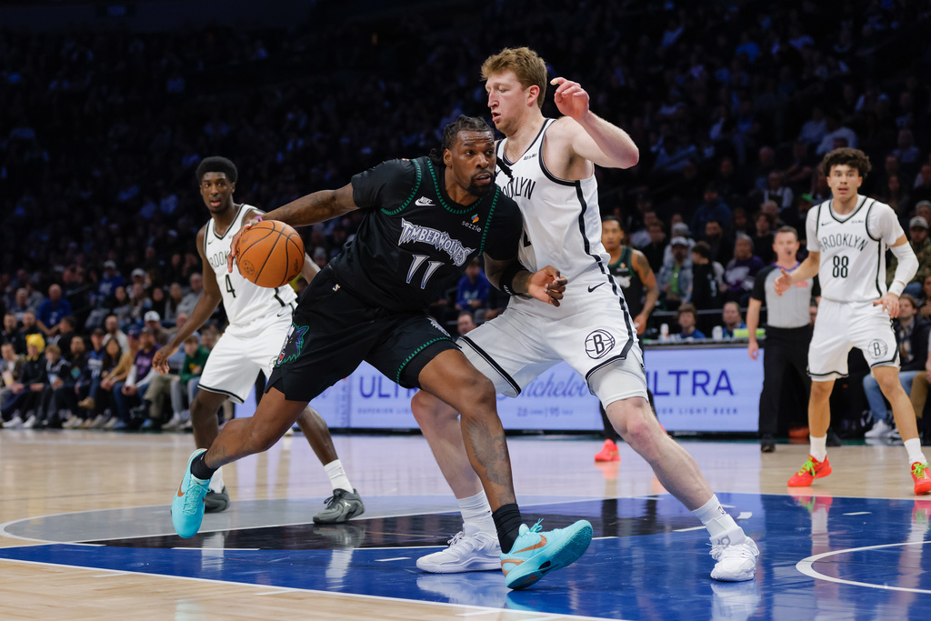 Minnesota Timberwolves center Naz Reid (11) drives to the basket while Brooklyn Nets forward Danny Wolf defends during the first half of an NBA basketball game, Saturday, Dec. 27, 2025, in Minneapolis. (AP Photo/Bailey Hillesheim)