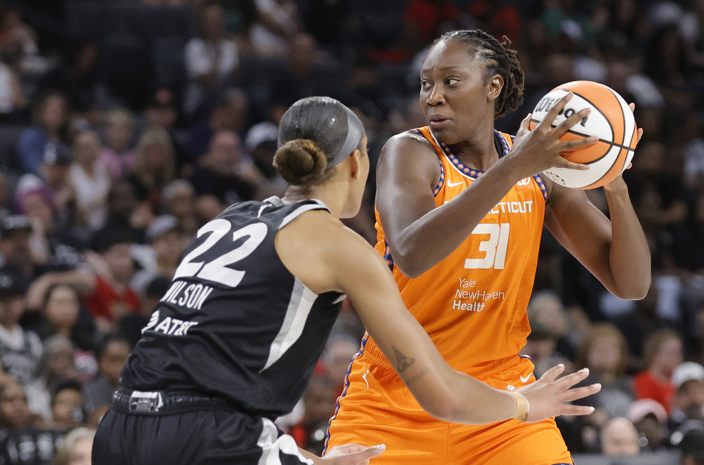 Connecticut Sun center Tina Charles (31) looks to pass the ball as Las Vegas Aces center A'ja Wilson (22) defends during the first half of a WNBA basketball game Sunday, Aug. 10, 2025, in Las Vegas. (Steve Marcus/Las Vegas Sun via AP)
