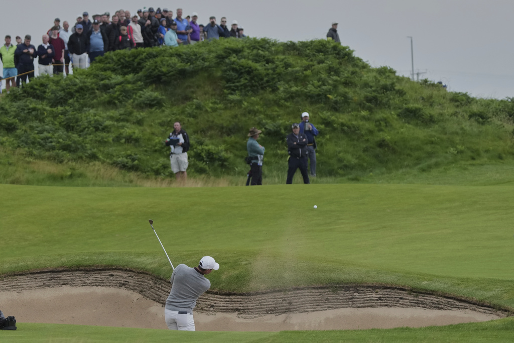 Rory McIlroy of Northern Ireland plays his second shot on12th hole from a bunker during the first round of the British Open golf championship at the Royal Portrush Golf Club, Northern Ireland, Thursday, July 17, 2025. (AP Photo/Jon Super)
