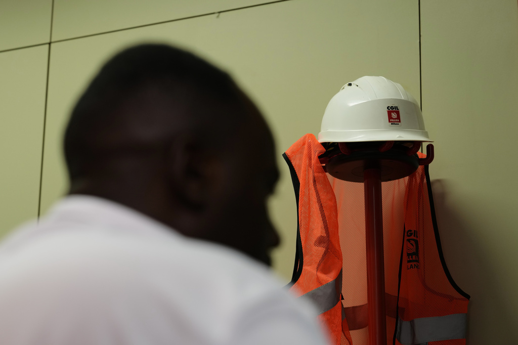 A former Caddell worker, who asked that his name not be published, speaks with The Associated Press during an interview in Milan, Italy, Monday, June 8, 2026. (AP Photo/Antonio Calanni)