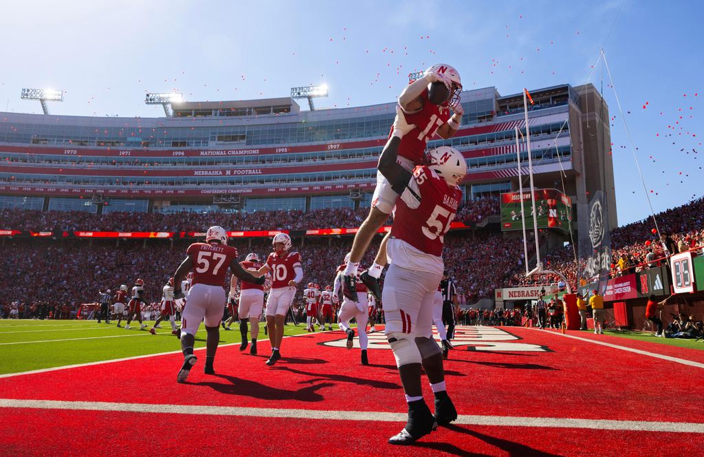 Nebraska's Tree Babalade (55) lifts Mekhi Nelson (13) in celebration of Nelson's touchdown against Maryland during the first half of an NCAA college football game Saturday, Oct. 3, 2026, in Lincoln, Neb. (AP Photo/Rebecca S. Gratz)