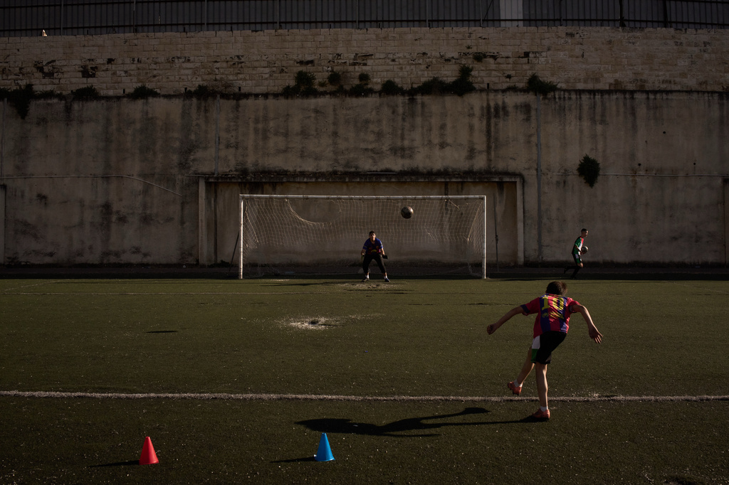 A Palestinian boy from a local soccer academy wearing a Barcelona jersey kicks a ball during a practice session at the municipal stadium in the West Bank city of Nablus, Thursday, May 7, 2026. (AP Photo/Leo Correa)