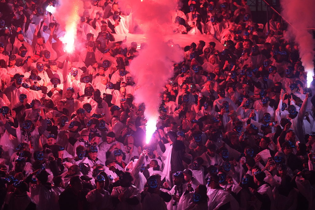 PSG fans light flare prior to the French League One soccer match between Paris Saint-Germain and Marseille in Paris, Sunday, Feb. 8, 2026. (AP Photo/Thibault Camus)