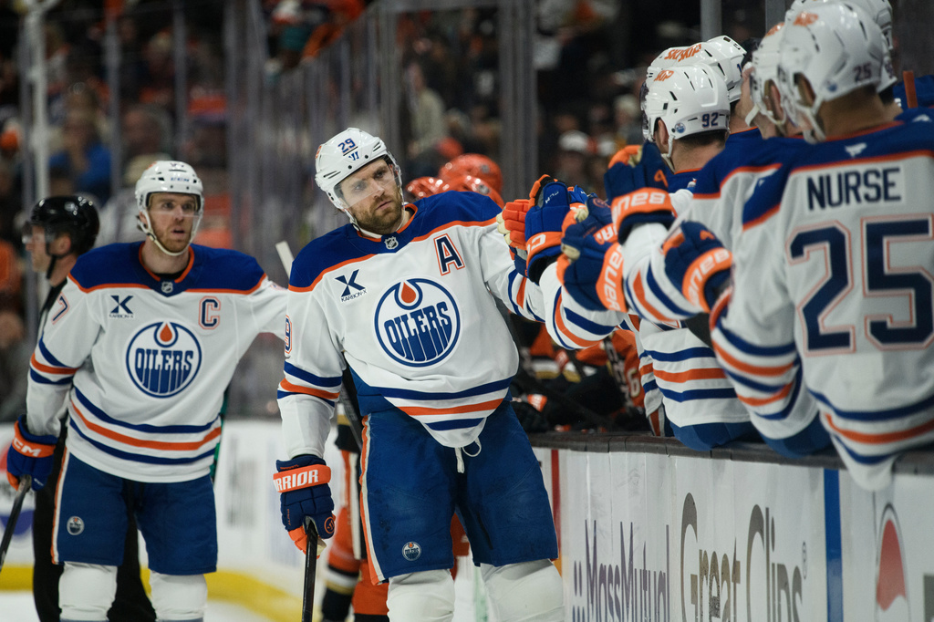 Edmonton Oilers center Leon Draisaitl celebrates a goal by center Ryan Nugent-Hopkins with the bench during the first period of Game 4 in the first round of an NHL hockey Stanley Cup playoff series against the Anaheim Ducks, Sunday, April 26, 2026, in Anaheim, Calif. (AP Photo/Kyusung Gong)