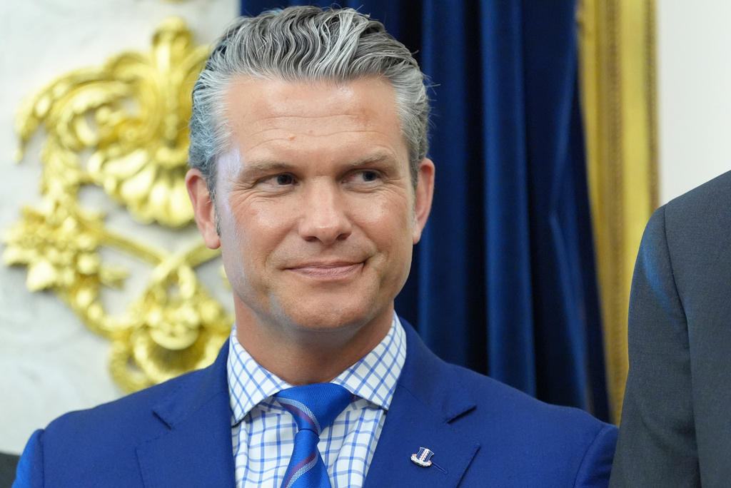 Defense Secretary Pete Hegseth listens as President Donald Trump speaks in the Oval Office of the White House during an executive order signing about quantum computing, Monday, June 22, 2026, in Washington. (AP Photo/Jacquelyn Martin)