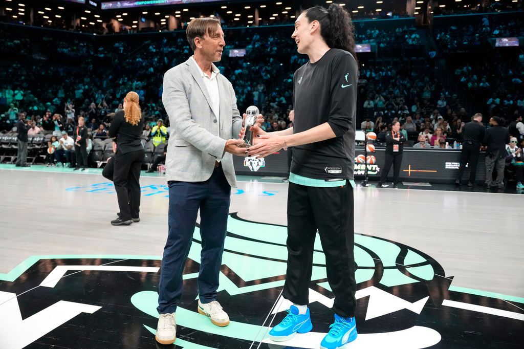The Associated Press' Global Sports Editor Josh Hoffner presents the Greatest Player award to New York Liberty forward Breanna Stewart ahead of a WNBA basketball game against the Dallas Wings, Tuesday, July 7, 2026, in New York. (AP Photo/Yuki Iwamura)