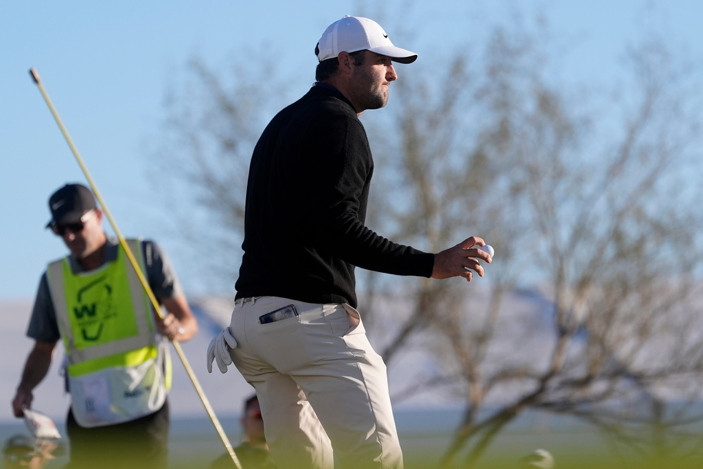 Scottie Scheffler waves to the crowd after getting a birdie on the 10th hole during the first round of the Phoenix Open golf tournament at the TPC Scottsdale Stadium Course Thursday, Feb. 5, 2026, in Scottsdale, Ariz. (AP Photo/Ross D. Franklin)