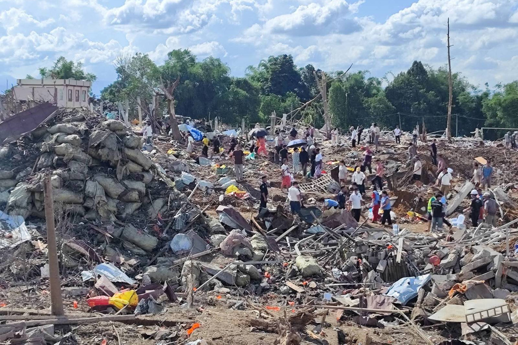 This handout photo provided by Palaung Land shows rescuers and local residents carrying out search operations in the aftermath of an explosion in Kaungtup village in Namhkam township in Shan state, Myanmar on Sunday, May 31, 2026. (Palaung Land via AP)