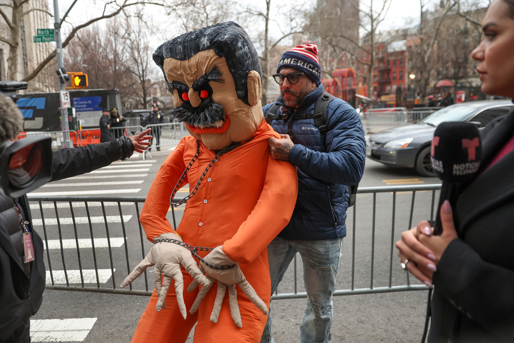 A demonstrator drags an effigy of former Venezuela President Nicolas Maduro outside Manhattan federal court before a pre-trial hearing in Maduro's drug trafficking case, Thursday, March 26, 2026, in New York. (AP Photo/Heather Khalifa)