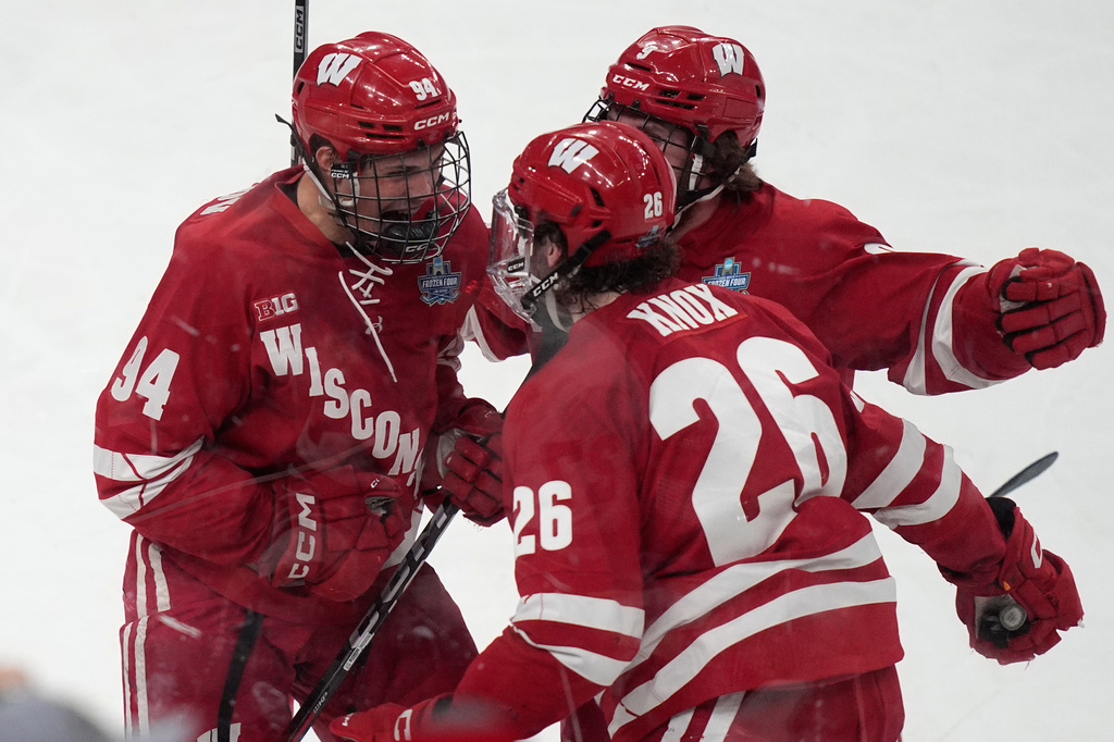 Wisconsin forward Vasily Zelenov, left, celebrates after scoring against Denver in the first period of the championship game at the NCAA Frozen Four men's college hockey tournament Saturday, April 11, 2026, in Las Vegas. (AP Photo/John Locher)