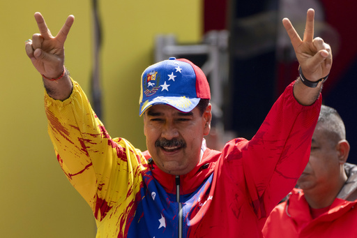 FILE - President Nicolas Maduro flashes victory signs during an event commemorating a 2004 speech by the late President Hugo Chavez, that is considered a key anti-imperialist moment by his supporters in the history of his Bolivarian Revolution, in Caracas, Venezuela, Feb 29, 2024. Maduro is the only candidate with a guaranteed spot on the ballot in Venezuela&rsquo;s upcoming presidential election. (AP Photo/Ariana Cubillos, File)
