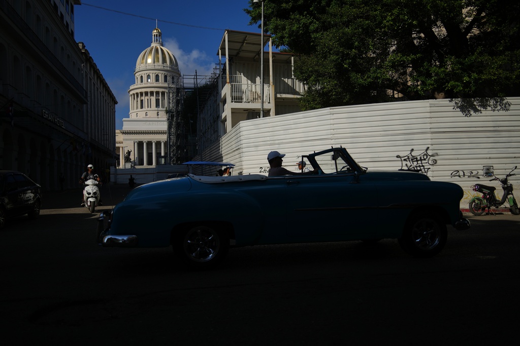 A man drives a classic American car in front of the Capitol in Havana, Monday, Jan. 26, 2026. (AP Photo/Ramon Espinosa)