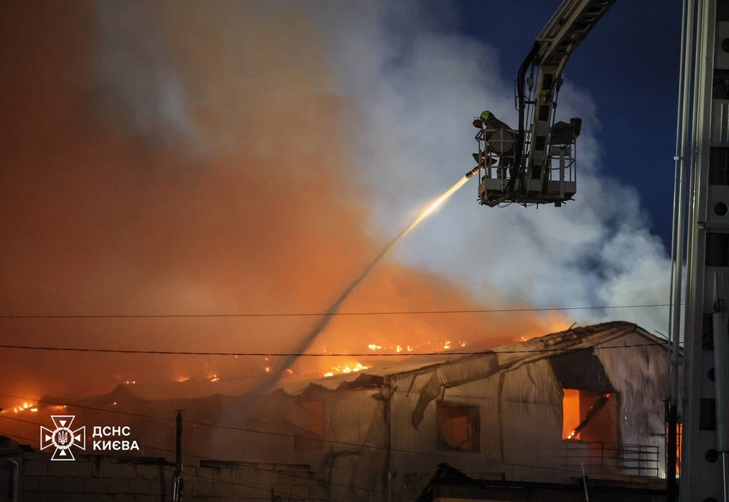 In this photo provided by the Ukrainian Emergency Service, emergency services personnel work to extinguish a fire following a Russian air attack in Kyiv, Ukraine, Wednesday, July 8, 2026. (Ukrainian Emergency Service via AP)
