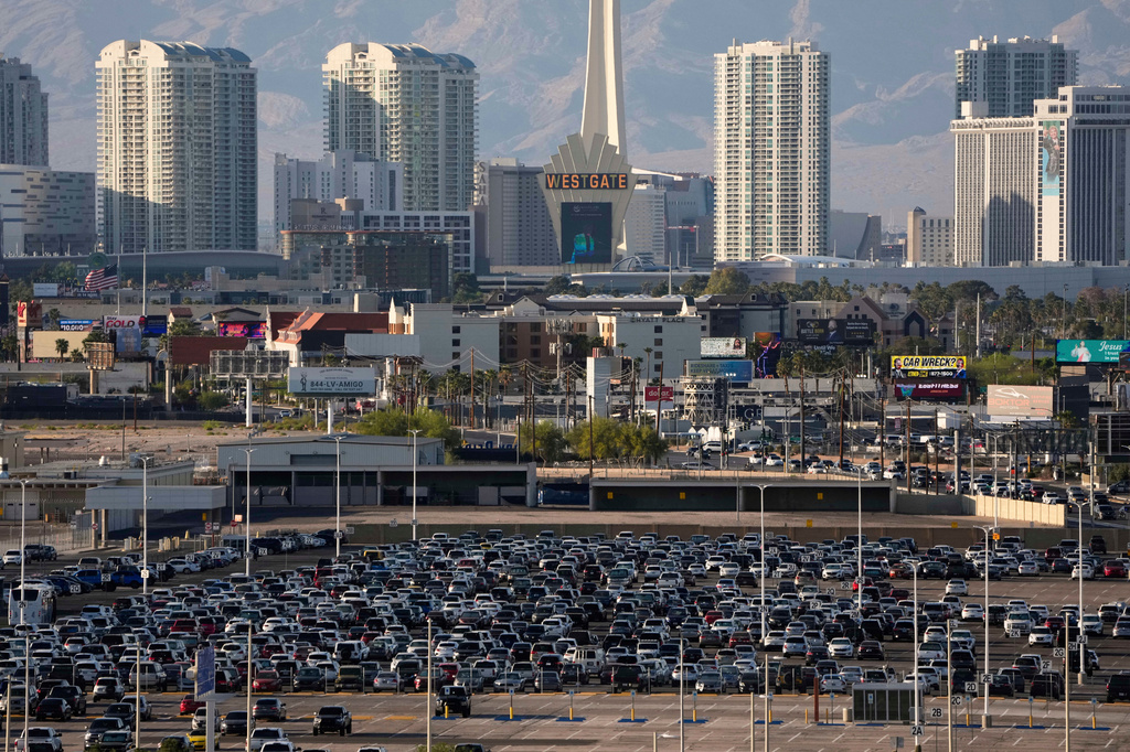 FILE - Cars fill a lot at Harry Reid International Airport near the Las Vegas Strip, April 9, 2025, in Las Vegas. (AP Photo/John Locher, File)