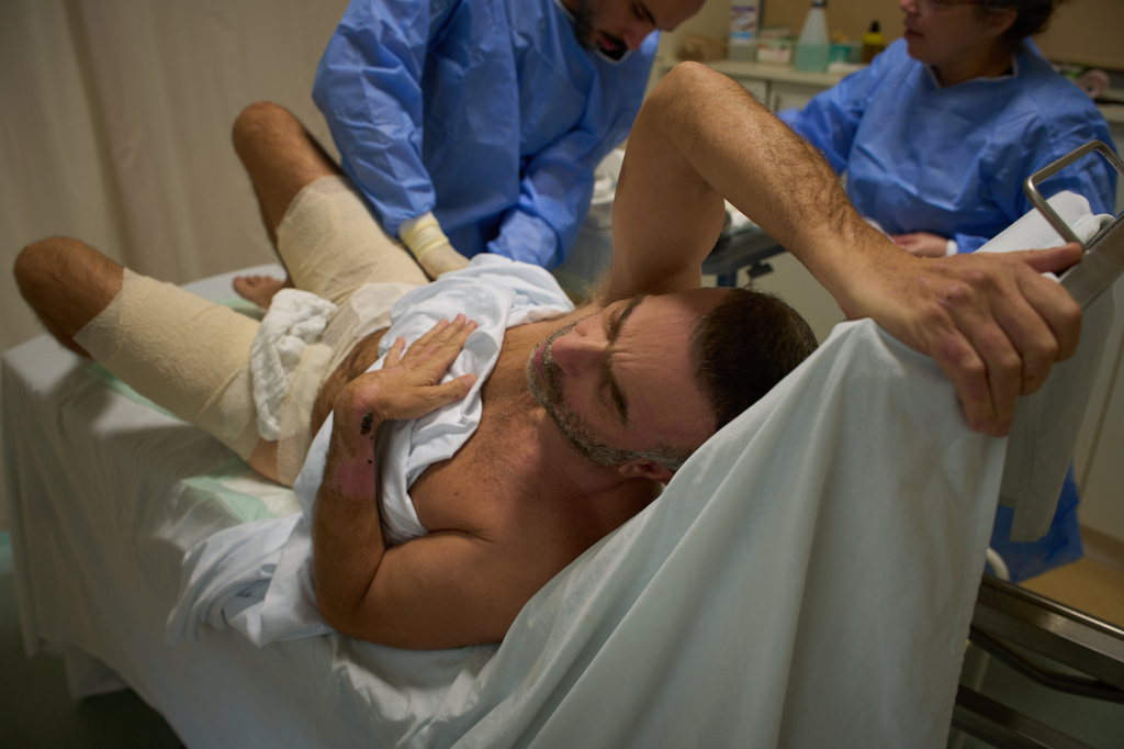 Mohammad Qubaisi, 53, with burn wounds from an Israeli airstrike on southern Lebanon undergoes surgery by Dr. Mohammed Ziara, left, and his team, at the Sidon Government Hospital in Sidon, Lebanon, Thursday, April 2, 2026. (AP Photo/Emilio Morenatti)