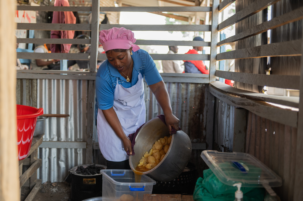 Arlette Basekawike prepares meals for Ebola patients at the Evangelical Medical Center (CEM) in Bunia, Congo, Monday, June 1, 2026. (AP Photo/Moses Sawasawa)