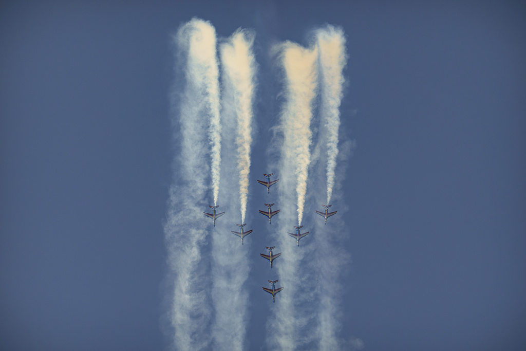 Pilots of the Patrouille de France (PAF), the precision aerobatics unit of the French Air and Space Force, perform above the runway of the Aurel Vlaicu airport, on the first day of the Bucharest International Air Show, BIAS 2025 in Bucharest, Romania, Saturday, Aug. 30, 2025. (AP Photo/Andreea Alexandru)