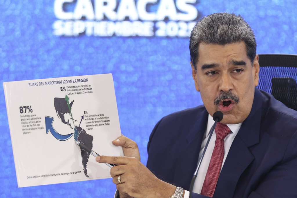 Venezuelan President Nicolas Maduro points at a map of the Americas during a press conference in Caracas, Venezuela, Monday, Sept 15, 2025. (AP Photo/Jesus Vargas)