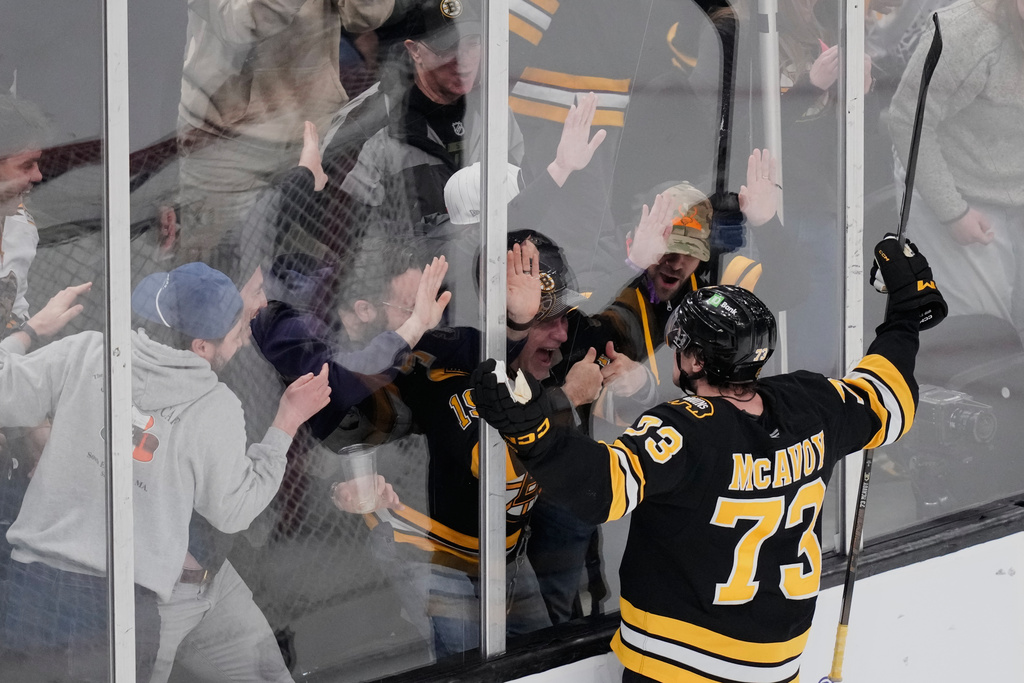 Boston Bruins defenseman Charlie McAvoy celebrates with fans after scoring the game-winning goal off Los Angeles Kings goaltender Darcy Kuemper during an overtime period of an NHL hockey game, Tuesday, March 10, 2026, in Boston. (AP Photo/Charles Krupa)