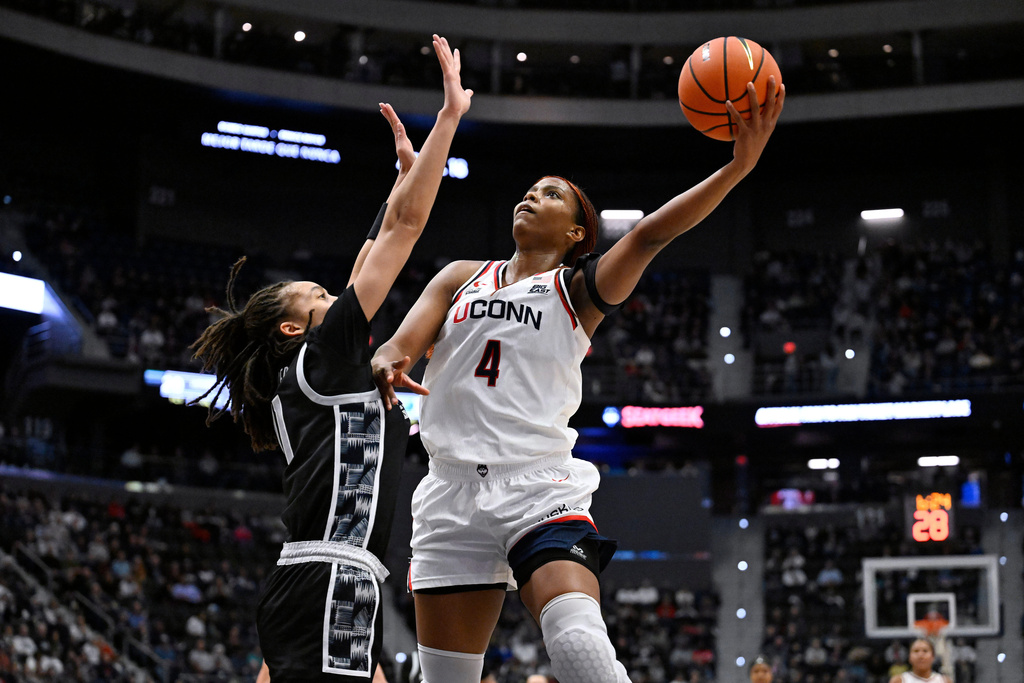 UConn guard Blanca Quinonez (4) shoots as Georgetown guard Khia Miller defends in the first half of an NCAA college basketball game, Thursday, Feb. 26, 2026, in Hartford, Conn. (AP Photo/Jessica Hill)