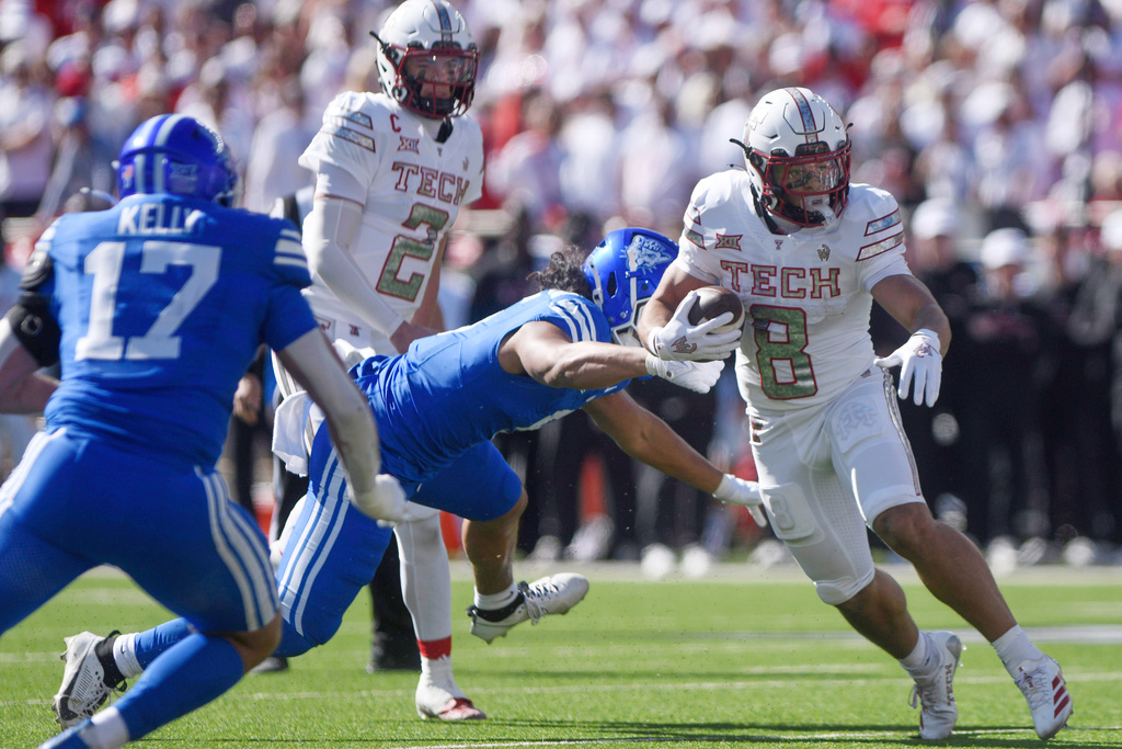 Texas Tech running back Cameron Dickey (8) runs with the ball during the first half of an NCAA college football game against BYU, Saturday, Nov. 8, 2025, in Lubbock, Texas. (AP Photo/Annie Rice)