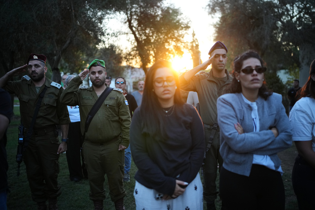 People attend a memorial service marking two years since the Oct. 7, 2023, Hamas cross-border attack on Israel, in Kibbutz Kfar Aza, southern Israel where many of its community members were Killed and abducted, Tuesday, Oct. 7, 2025. (AP Photo/Ohad Zwigenberg)