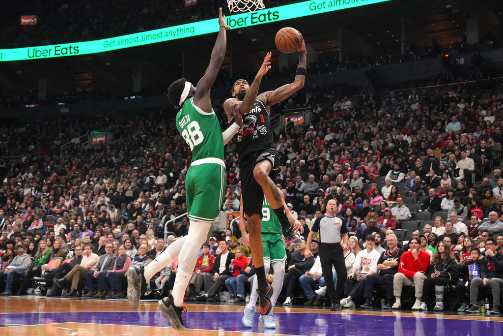 Toronto Raptors forward Brandon Ingram (3) goes up to shoot over Boston Celtics' Neemias Queta (88) during first-half NBA basketball game action in Toronto, Sunday Dec. 7, 2025. (Chris Young/The Canadian Press via AP)