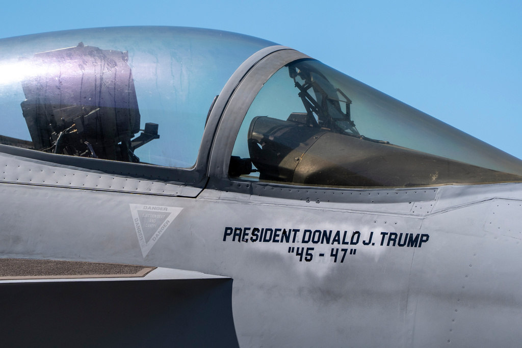 An F/A-18E fighter jet with President Donald Trump's name stenciled onto is seen aboard the USS George H.W. Bush aircraft carrier in the Atlantic Ocean off the coast of Norfolk, Va., Saturday, Oct. 4, 2025. (AP Photo/Alex Brandon, Pool)