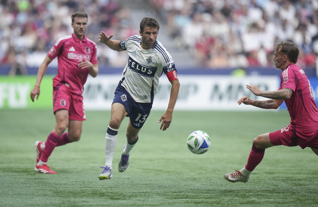 Vancouver Whitecaps Thomas Muller, centre, and St. Louis City's Conrad Wallem, right, vie for the ball during the first half of an MLS soccer match, in Vancouver, on Saturday, August 23, 2025. (Darryl Dyck/The Canadian Press via AP)