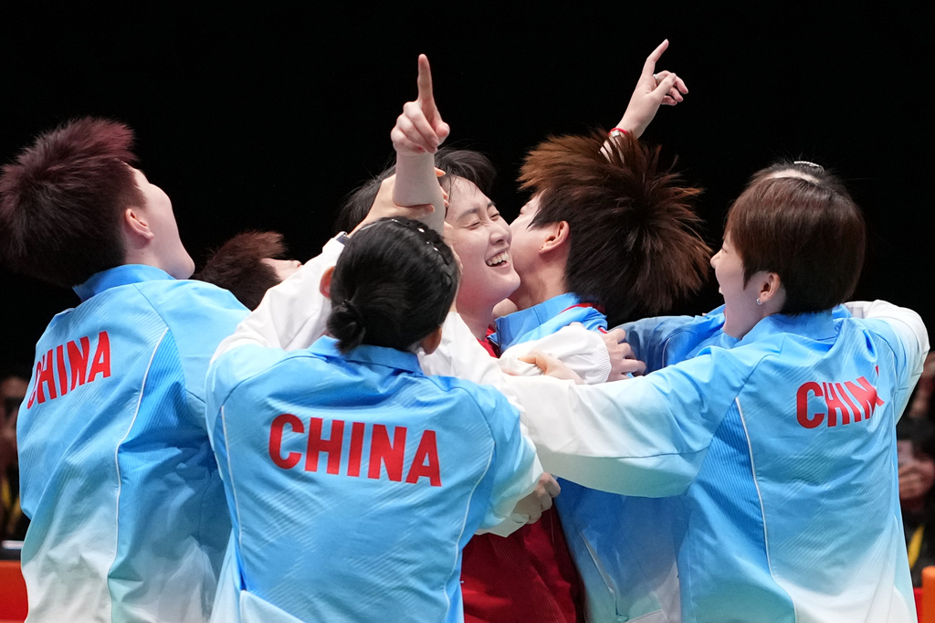 China's team celebrate after winning against Japan during the women's badminton team finals at the Asian Games in Ichinomiya City, Japan, Thursday, Sept. 24, 2026. (AP Photo/Aaron Favila)