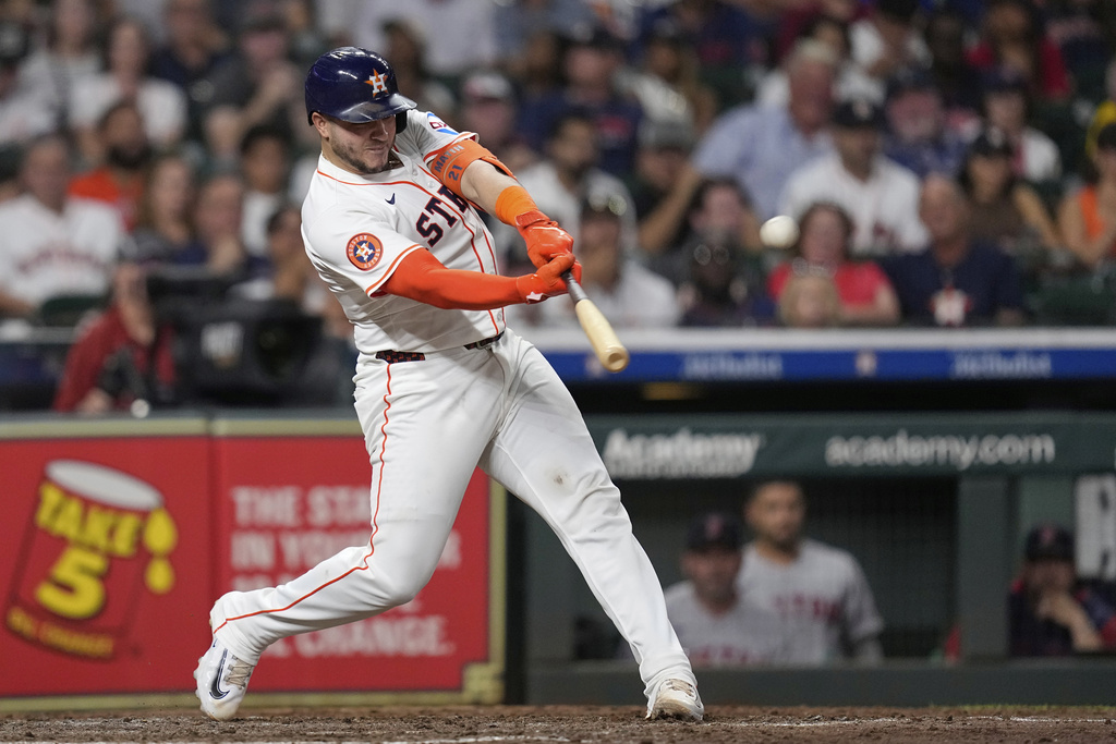 Houston Astros' Yainer Diaz hits a two-run home run against the Boston Red Sox during the sixth inning of a baseball game Wednesday, Aug. 13, 2025, in Houston. (AP Photo/David J. Phillip)